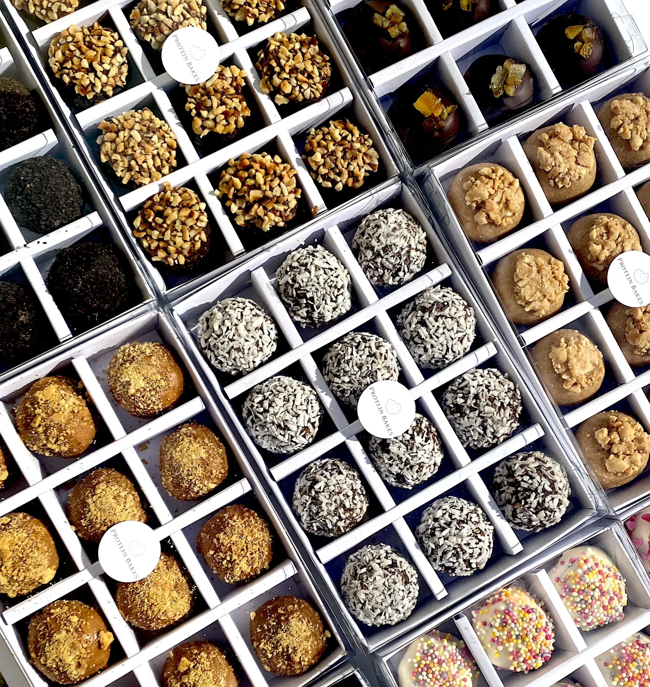 Selection boxes of assorted Protein Bakes, from hazelnut and coconut to Biscoff and sprinkles